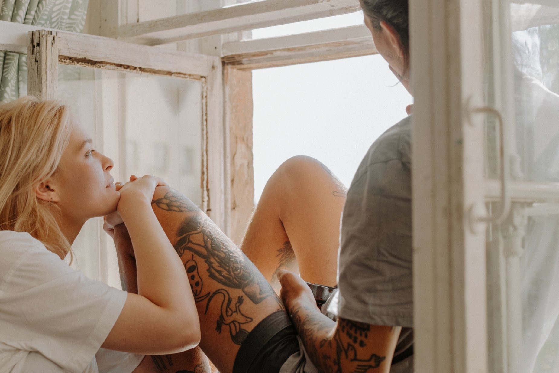 Woman in White Tank Top With Tattoo on Her Right Arm